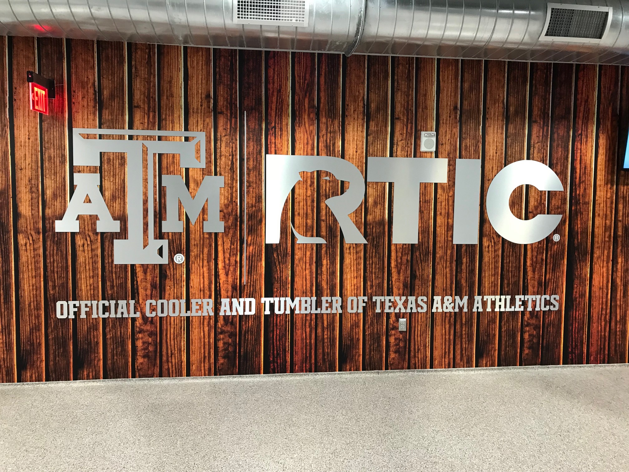 metal signage on wooden wall